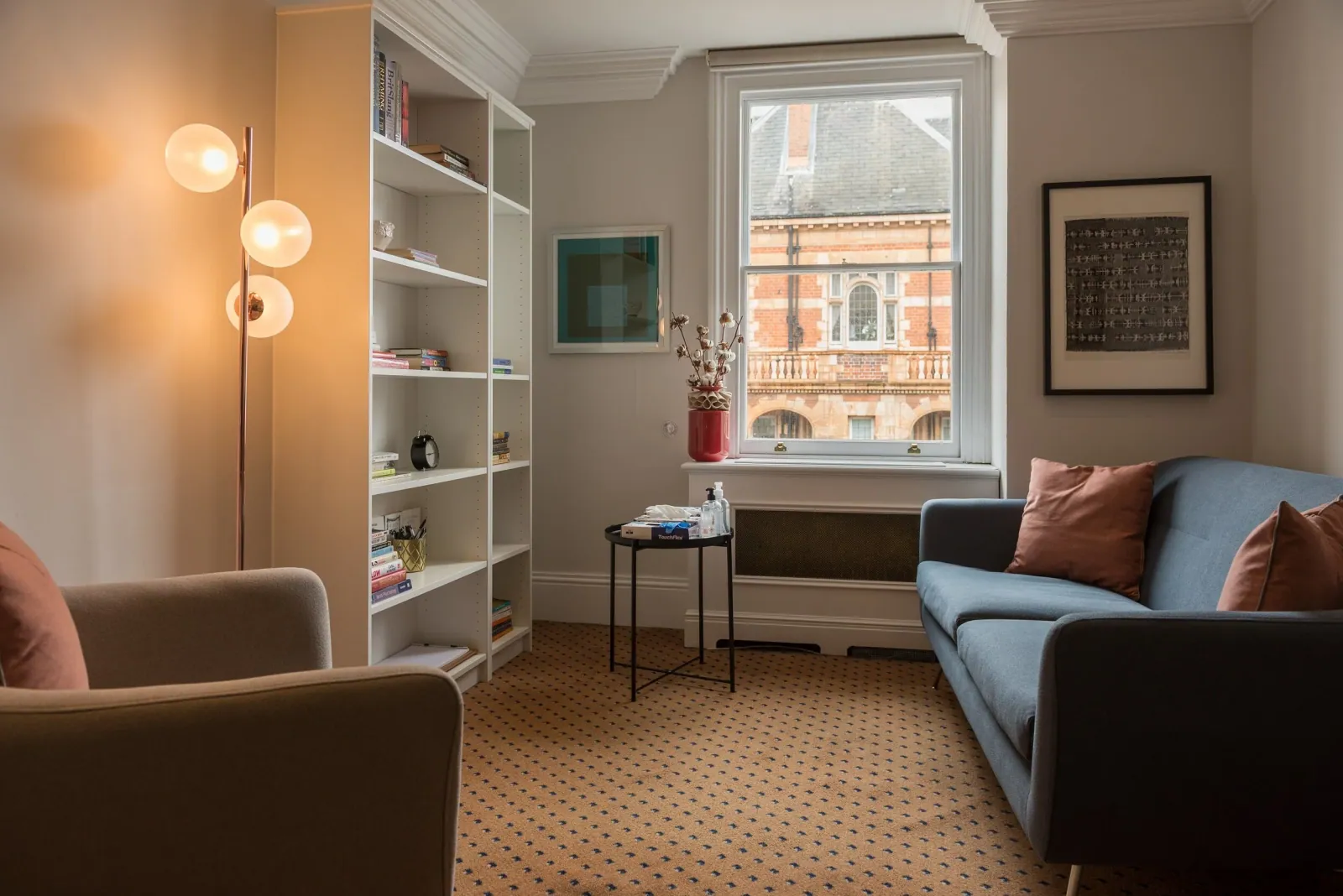 Quiet consulting room with bookshelf and seating